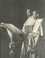 Two monks singing with choir book