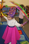 Little girl dancing in dress up clothes