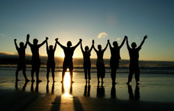 photo: people holding hands on the beach in a sunset