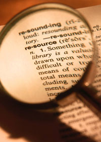 Photo of magnifying glass over the word resources printed on a page