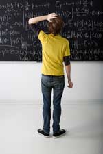 student standing at chalkboard