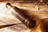 antique spyglass and papers on desk