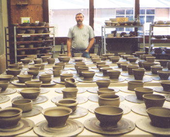 Erik Land surveys unfinished  pots made by his students