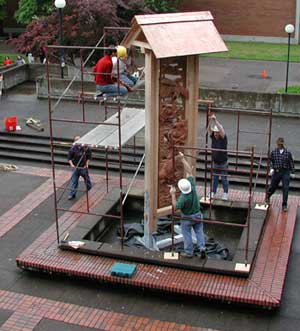 Master woodcarvers from Japan, Yoshiki Kawada and Mineo Shimada, help install a mahogany relief panel on Lane Community College main campus. The sculptors collaborated with students in instructor Lee Imonen's site specific sculpture class to create the piece, titled 