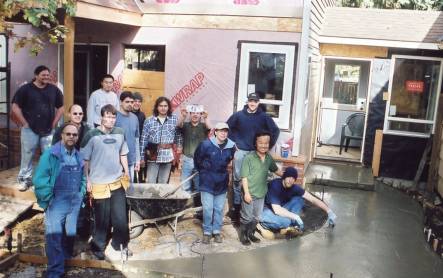 Construction technology students at Lane Community College take a break with family members at a home under remodel as a class project.