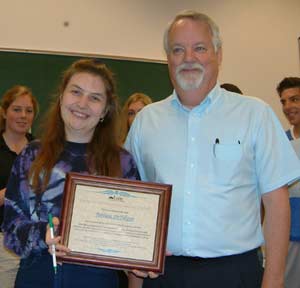 Social science instructor Barb DeFilippo is  congratulated by department chair Ken Murdoff