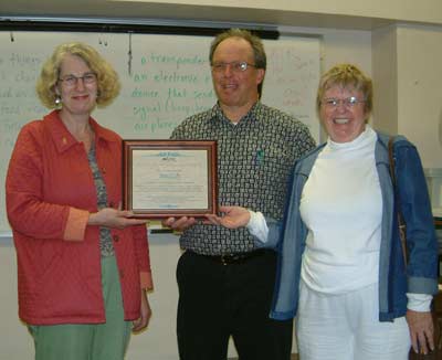ESL instructor Stan Paulic is joined by President Mary Spilde (left) and division chair Pat John to celebrate his award for outstanding teaching.