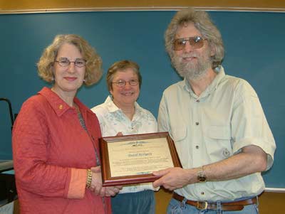 English instructor David Rothgery accepts an award for outstanding teaching from President Mary Spilde, while division chair Susan Swan looks on.
