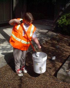 Student Worker putting trash into can